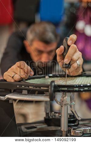 Tennis Stringer Holding Awl And Doing Racket Stringing