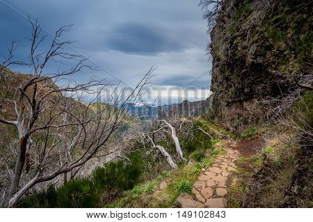Dangerous hiking path at the mountains of Madeira island. Way back from Pico Ruivo to Pico Arieiro. Madeira, Portugal.
