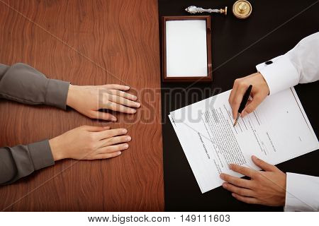 Woman and notary public signing documents