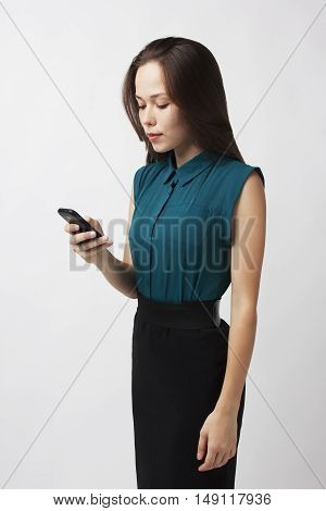 business woman dials a phone number in his hand on a white background