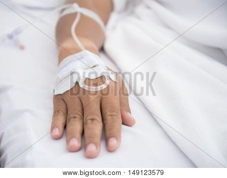 Close up of a patient in hospital with saline intravenous (iv) select focus