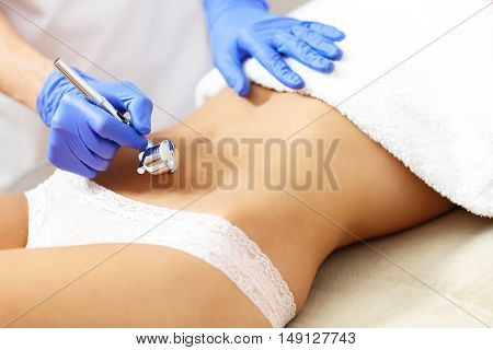 Picture of woman having abdomen mesotherapy in beauty salon
