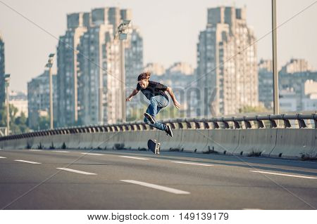 Skater Doing Tricks And Jumping On The Street Highway Bridge. Free Riding Skateboard