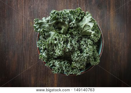 Fresh Sliced Italian Kale Salad On A Blue Plate. Dark Background