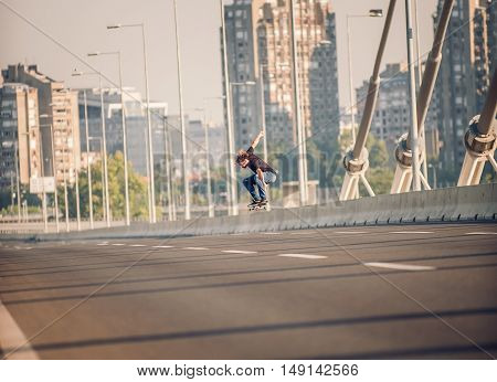 Skater Doing Tricks And Jumping On The Street Highway Bridge. Free Riding Skateboard