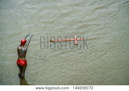 Statue and drifting objects.
Skopje, Macedonia - September 25, 2016: Statue and drifting wooden cross in the flooded river Vardar Macedonia.
Statue and drifting wooden cross.
