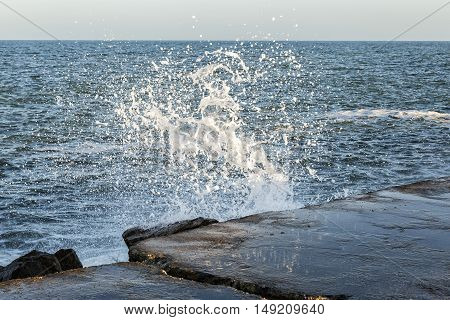 weaves breaking and splashing on concrete surface creating original forms