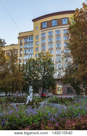 BELGOROD RUSSIA - SEPTEMBER 10 2016: Holy Trinity Boulevard in Belgorod Russia. Oldest sculpture fountain "Girl with gosling" (1953 built) on the background of the residential complex "Seven." Old and modern side by side.