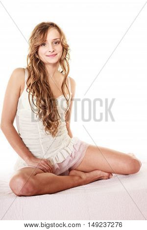 Health and beauty concept. Young lovely woman long curly hair relaxing on her bed at morning