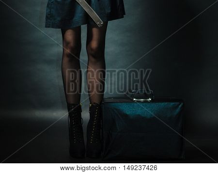 Journey and travel. Retro stylished girl with vintage big bag suitcase valise. Stylish victorian woman on dark background.