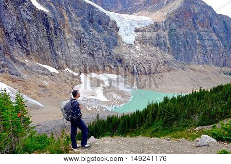 Man hiker on mountain top in Edith Cavell meadows. Jasper National Park. Alberta. Canada.