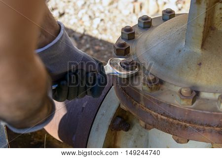 Workman looking to unlock the rusty valve.