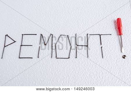 On a white background lined with nails word repair