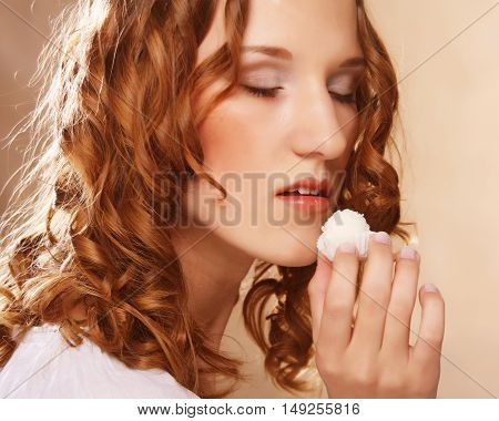 beauty portrait of a cute  girl in act to eat a candy with cocoanut