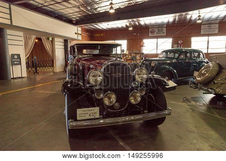 El Segundo, CA, USA - September 26, 2016: Maroon and black 1932 Buick convertible with a white soft top displayed at the Automobile Driving Museum in El Segundo, California, United States. Editorial use only.