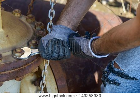 Workman looking to unlock the rusty valve.