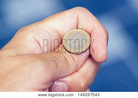 Businessman hand tossing coin to flip on heads or tails concept of chance opportunity and decision making
