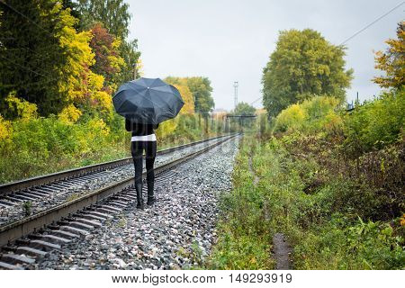 Girl, Umbrella And Rails In Autumn Day
