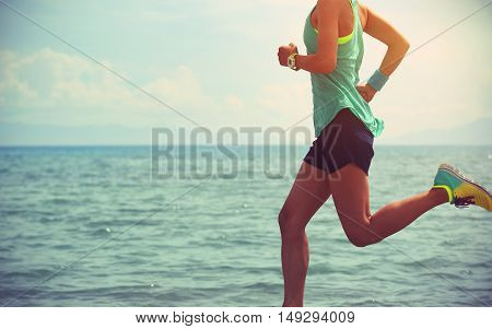 healthy young fitness woman trail runner running on seaside