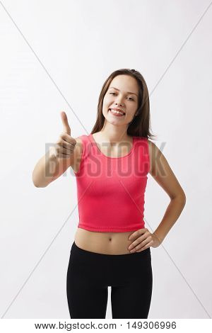 Sport girl show thumb up isolated on white background. Running fitness sport woman jogging smiling happy