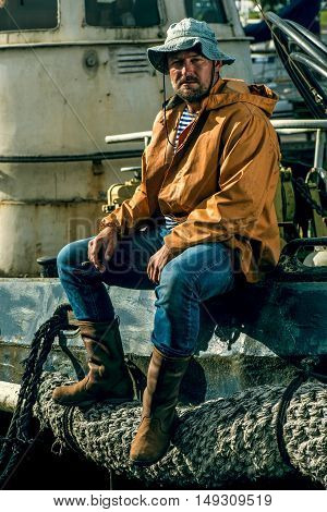 Old salt man on his rusted ship