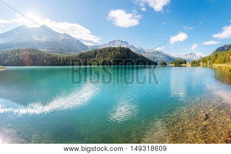 Great view of the azure pond Champfer in alpine valley. Popular tourist attraction. Picturesque and gorgeous scene. Location Swiss alps, Silvaplana village, district of Maloja, Europe. Beauty world.