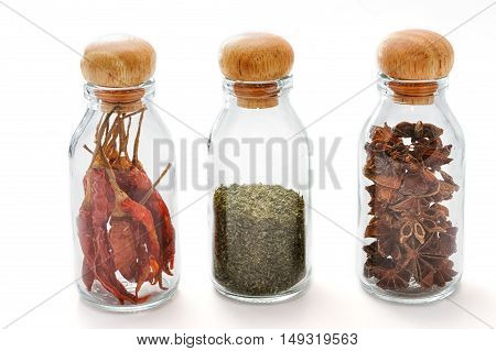 Set of assorted colorful spices in glass bottle isolated on white background