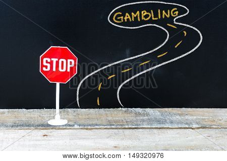 Mini Stop Sign On The Road To Gambling