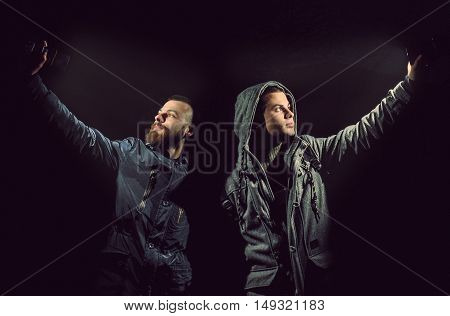 Two men are taking a Selfie with a cellphone
