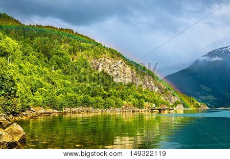 Rainbow above Nordfjorden fjord near Loen in Norway