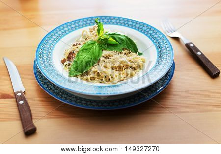 noodles decorated with herbs served on a wooden table