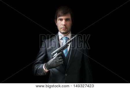 Hitman Or Murderer With Pistol With Silencer On Black Background