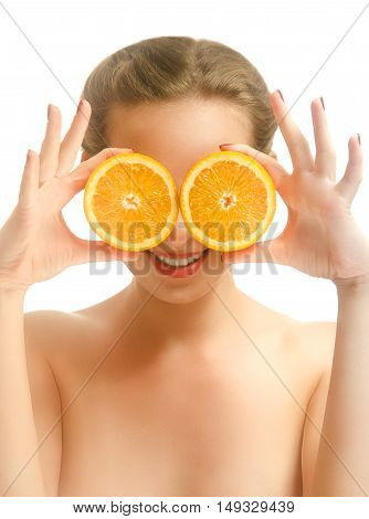 Young funny woman covering her eyes with orange slices. White background.