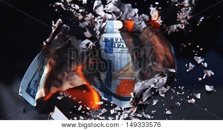 burning dollar bill as a symbol of inflation and the financial crisis