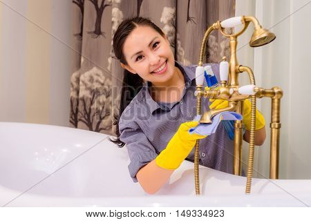 Young beautiful asian woman housekeeping in the bathroom