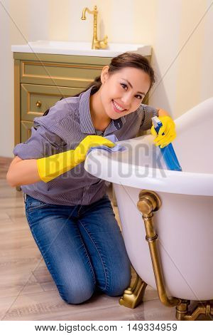 Young beautiful asian woman housekeeping in the bathroom