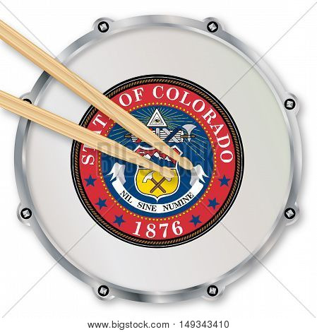 Colorado state seal snare drum batter head with tuning screws and with drumsticks over a white background