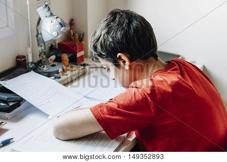 Young male student preparing for exams at home