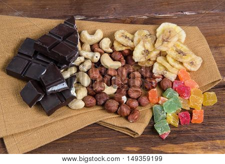 Chocolate and nuts with napkin on a wood