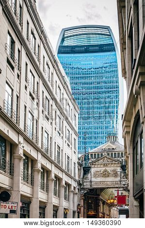 LONDON UK - AUGUST 21 2015: Street in the city of London with the contrast between historical buildings and new skyscrapers at Leadenhall Market