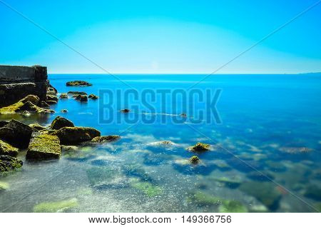 beach of crystalline water with rocks on the left side