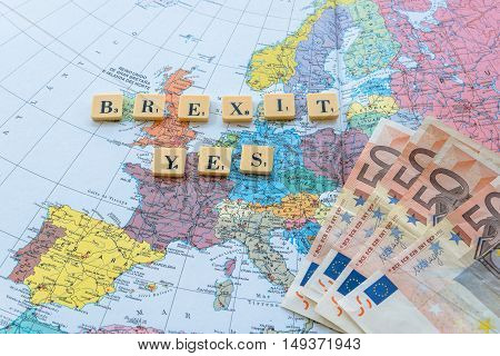 London UK - June 12 2016: Brexit Yes words on european map with euro money. The United Kingdom European Union membership referendum on 23 June 2016