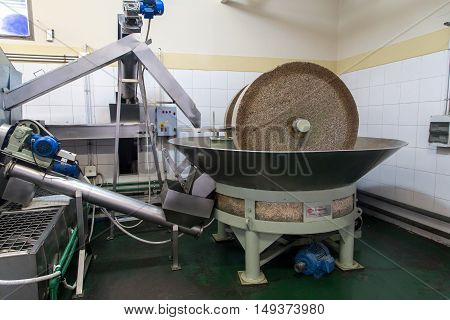 Mendoza, Argentina - November 23, 2015: A grinding stone inside an olive oil factory
