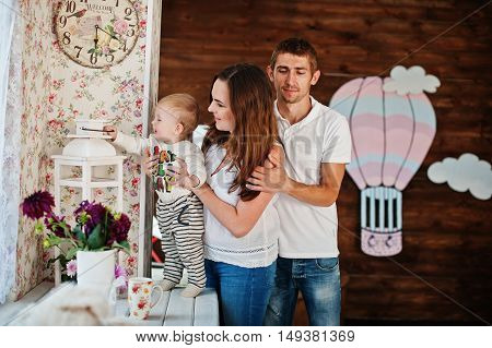 Young Caucasian Happy Family In Love Idoor Room With Vintage Decor