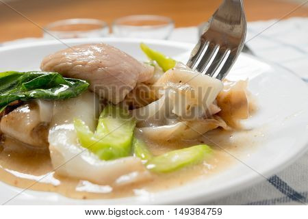 Rad Na, Famous Thai Chinese Style Wide Rice Noodle Dish With Tasty Tender Pork With Thick Gravy Sauc