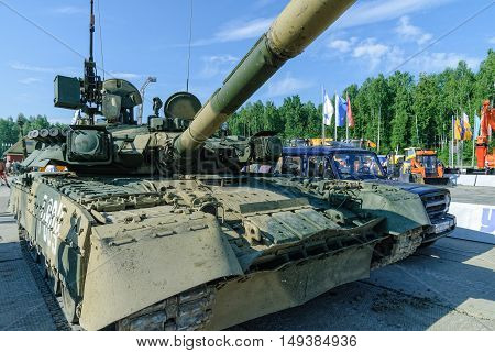 Nizhniy Tagil, Russia - July 12. 2008: Visitors examine military equipment on exhibition range. T80U modernized tank. Russian Arms Expo