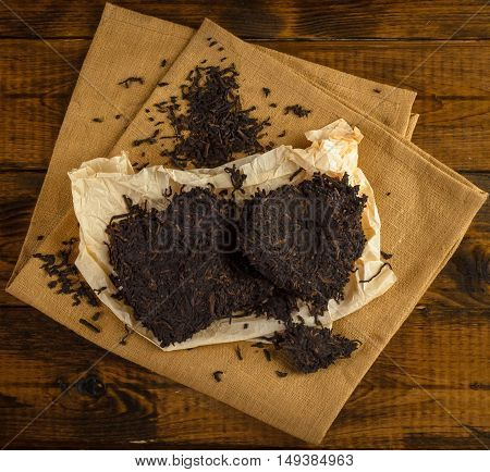 Aromatic black pu-erh tea from yunnan province in a China. Leaves undergoes double fermentation and compressed into bricks. Healthy drink.