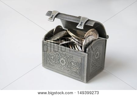 Ajar decorative chest with Russian rubles on a white background