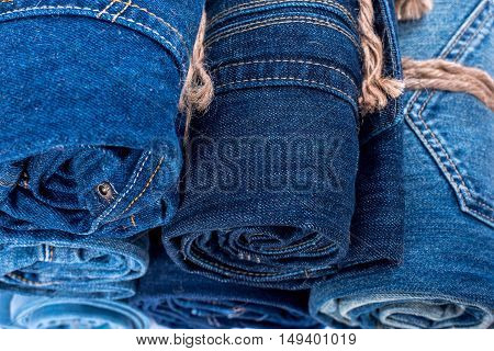 the jeans twisted in rolls on a white background