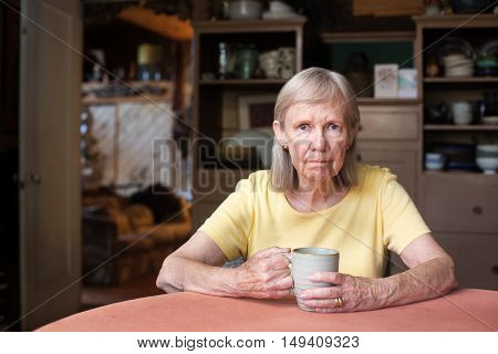Senior Woman Sitting At Table